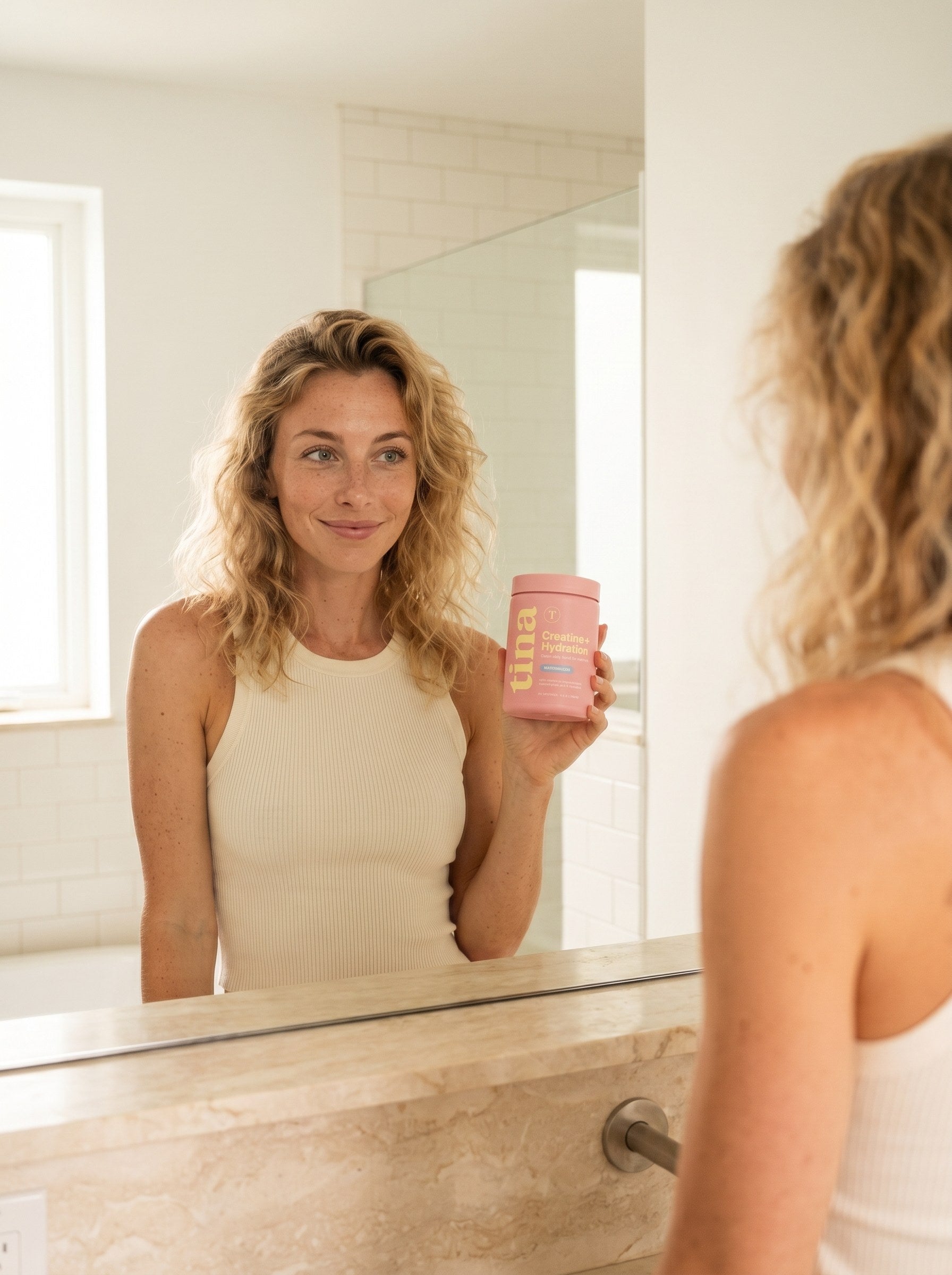Energized morning with TINA โ same woman, glowing and radiant, holding the pastel pink TINA jar